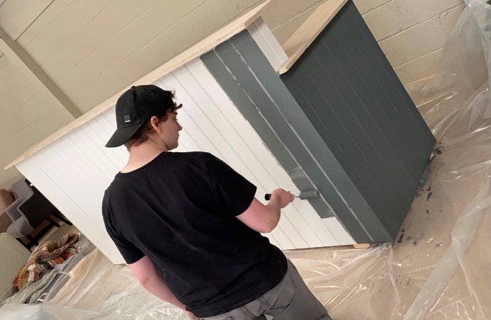 Photo below of Evan, new apprentice, painting our reception desk in the new showroom